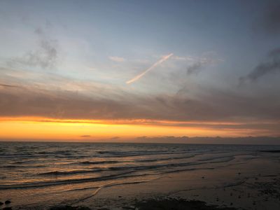 image of a sunset in the distance over a beach scene