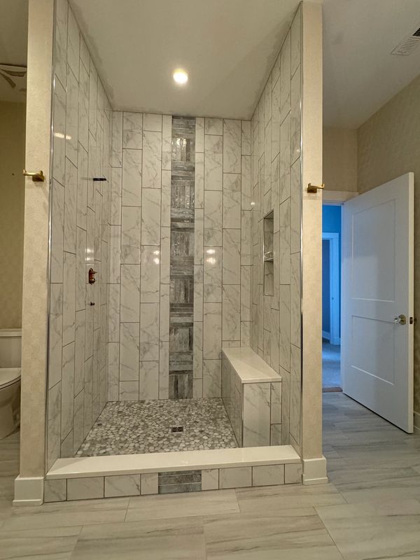 Custom tile shower 5’x4’ with complementing ceramic 12”x24” tile floor