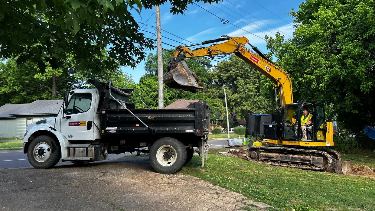 Excavator loading dirt into a dump truck.
