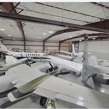 Group of jets in a large hangar.