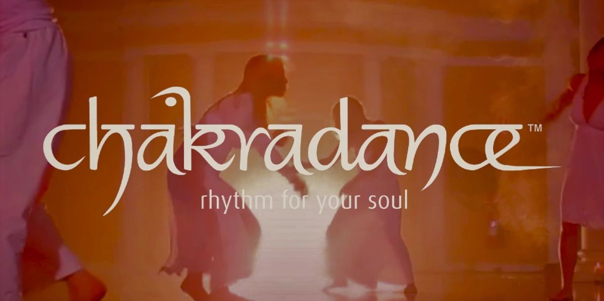 A group of people at a Chakradance workshop moving in sacred rhythm to specially composed music