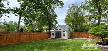Backyard with a shed and stained fence.  