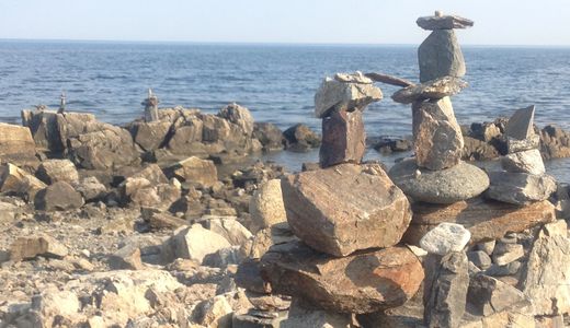 Rock piles (cairns) at seashore. Originally created by an artist, re-created each year.