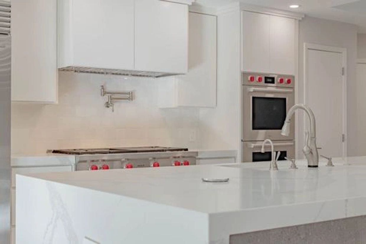 kitchen with white quartz countertop and wolf appliances