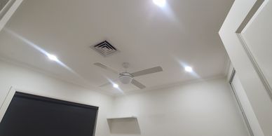 A bedroom with 4 new downlights, with a Ceiling fan.