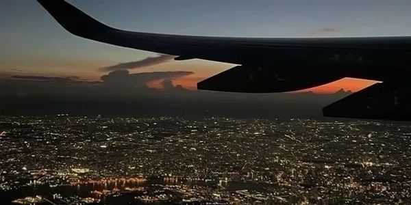 City lights viewed from an airplane at dusk.