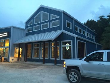 Blue metal storefront building with decorative columns.
