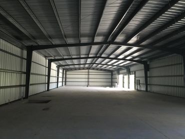 Interior of a new, empty metal building structure.