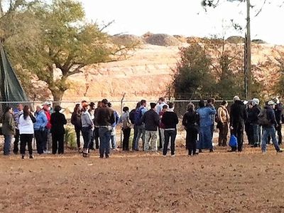 Group looking at the growing pile of dirt and debris at the Rolling Hills Landfill