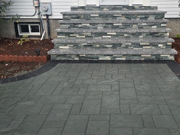 PAVERS: UNILOCK PREMIER SLATE
BORDER: TREO PREMIER 4X9 DARK CHARCOAL 
GRANITE TREADS, VENEER