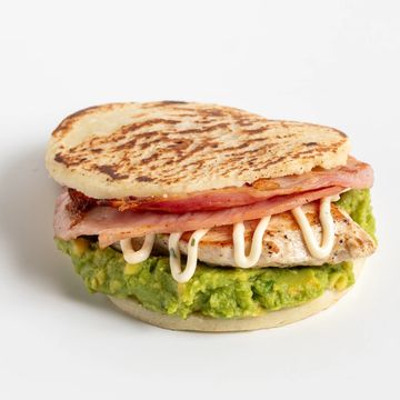 Grilled sandwich with avocado, chicken, bacon, and mayonnaise.