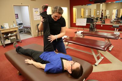 stretch relief pain therapy Williamston sc Nicole stretching patient for sciatica