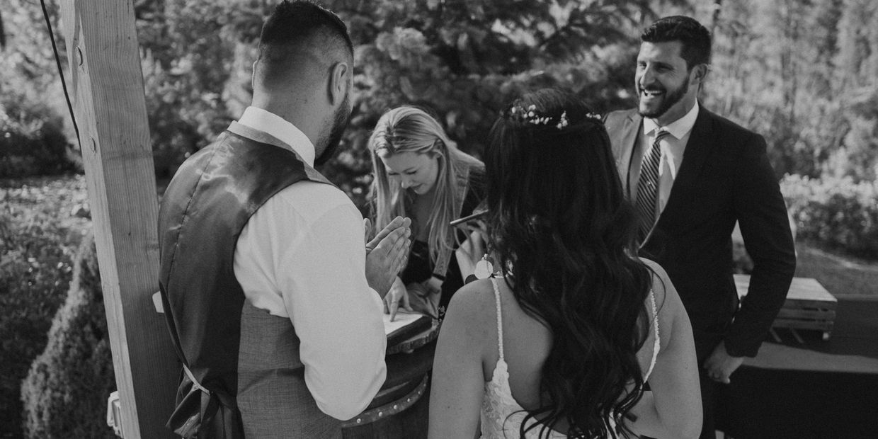 Signing marriage license with wedding planner and wedding officiant