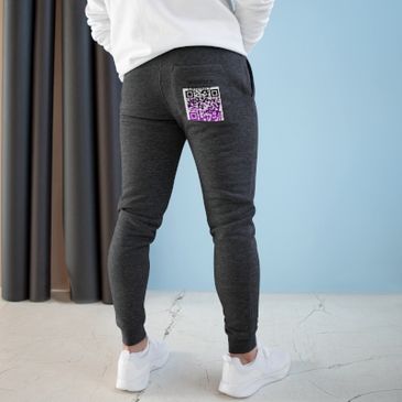 Person wearing dark joggers with a colorful QR code on the back pocket.