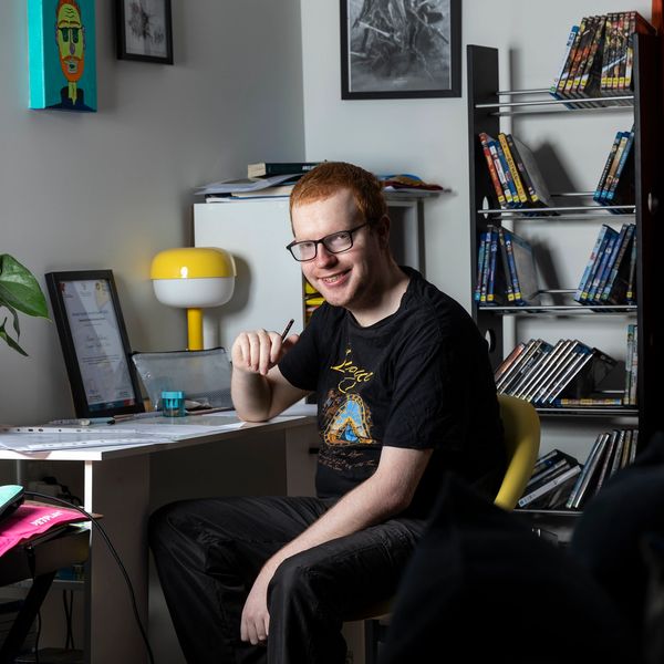 Liam sitting at his writing desk