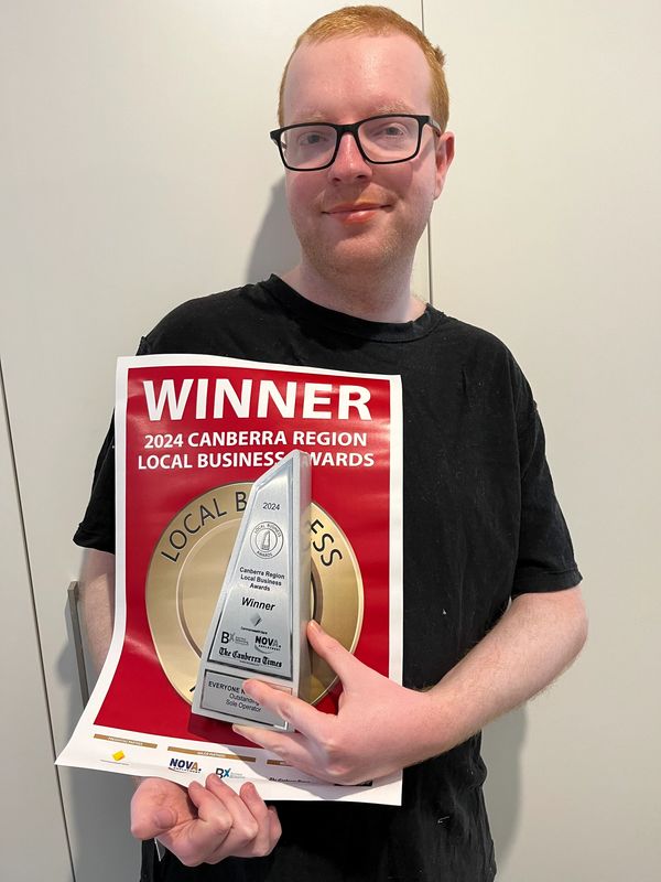 Liam with his award trophy and poster