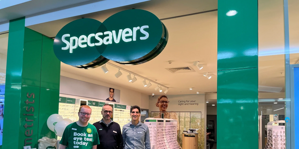 Liam and the two store managers from SpecSavers Woden - Hubert and Raj - at the front of the store.