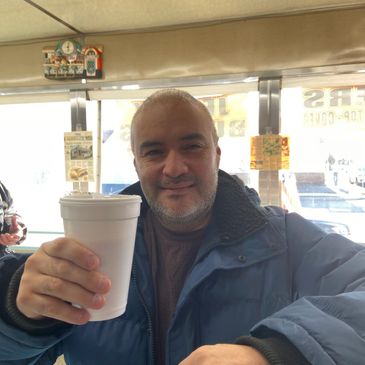 Male customer holding a cup of coffee