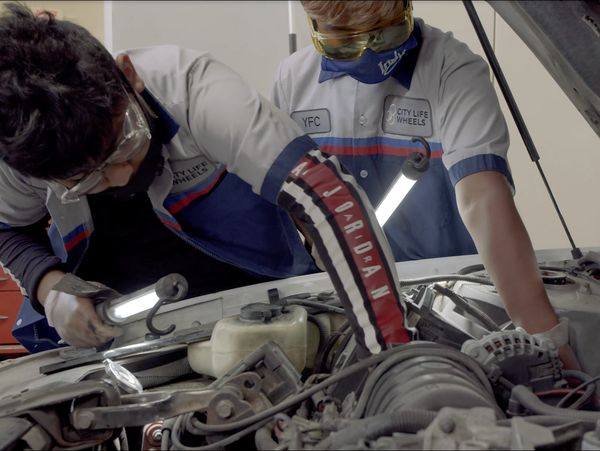 The Match students working on a car