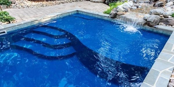 RiverPools D40 maya blue tanning ledge with spillway water feature from pond