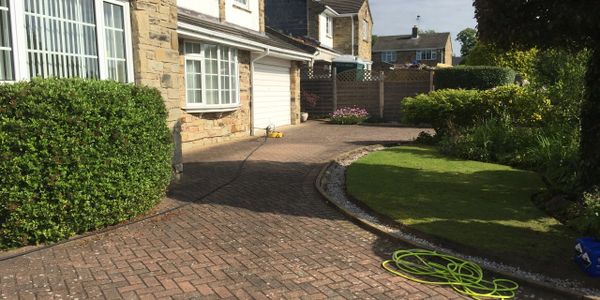 Driveway in front of a house filled with gutter