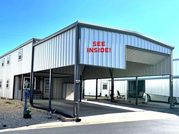 Modern metal carport with signage about interior photos.
