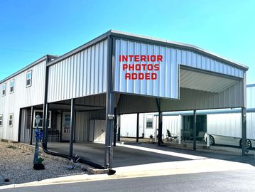 Modern metal carport with signage about interior photos.