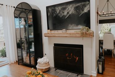 Custom made reclaimed wood mantel and antique brass fireplace screen