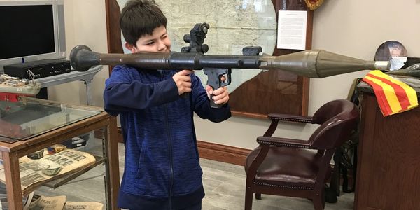 young student explores how veterans used weapons in protection of our freedoms