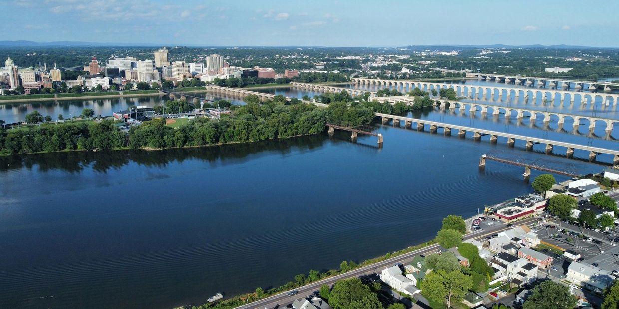 Aerial view of a city with multiple bridges over a wide river.