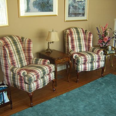 Set of upholstered antique wingback chairs.