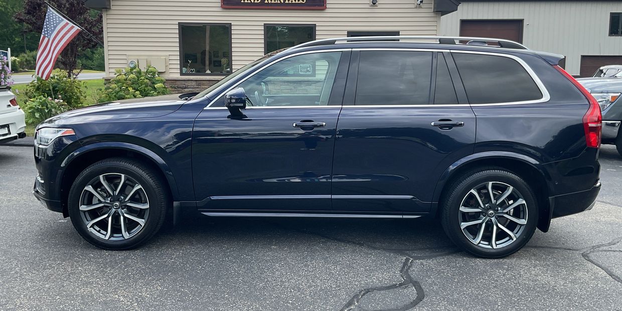 Blue SUV parked on asphalt near a building.