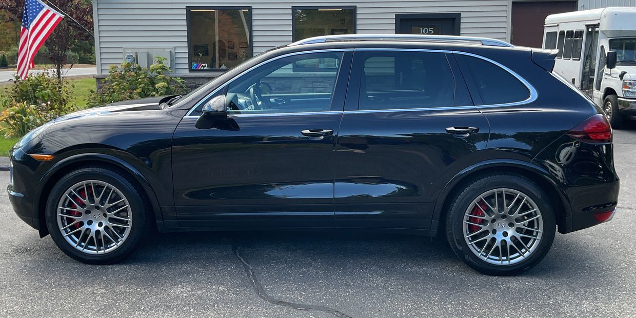 Black luxury SUV parked outside a building.
