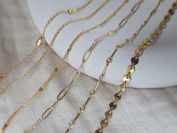 Fine gold permanent jewelry chains available at Skyline Ink Studio in Raleigh