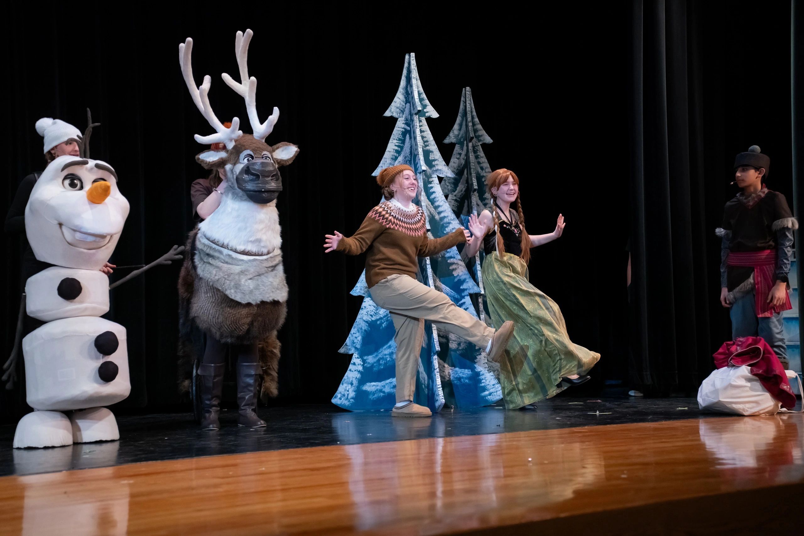 Theater performance with characters from Frozen on stage.