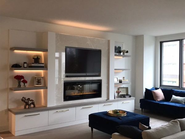 Custom Media Center made wtih triple shelving, stone backing, fireplace.