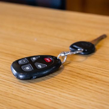 Basic key and Remote FOB on a desk, cheap locksmith near me