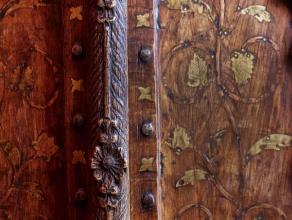 Close-up of ornate carved wooden doors or panels.