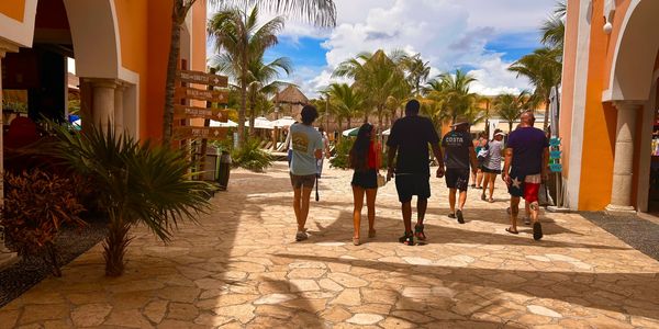 Three people walking through the Costa Maya cruise port heading back to Carnival Breeze ship