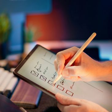 Person using a stylus to check tasks on a digital tablet checklist.