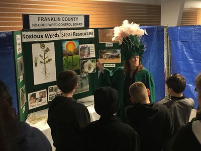 FCNWCB Education Coordinator Betsy Crysel in her Scotch thistle costume speaks to a school group.