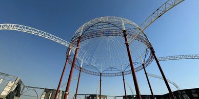 A large metal dome structure under a clear blue sky.