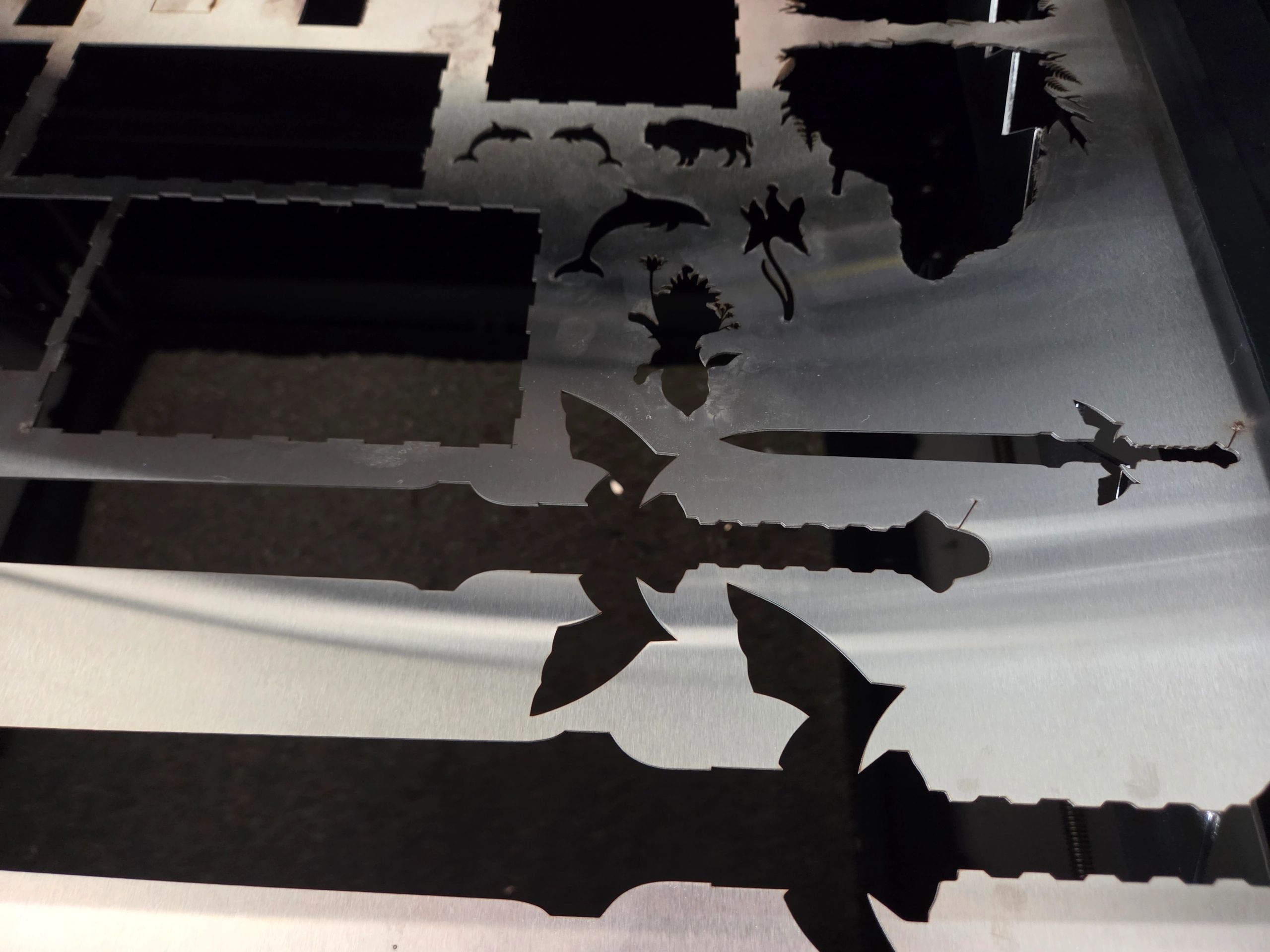 Metal sheet with animal and plant cutouts