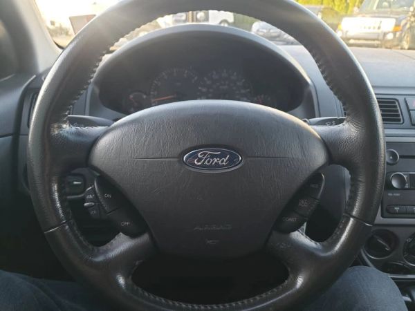 Steering wheel of a Ford car.