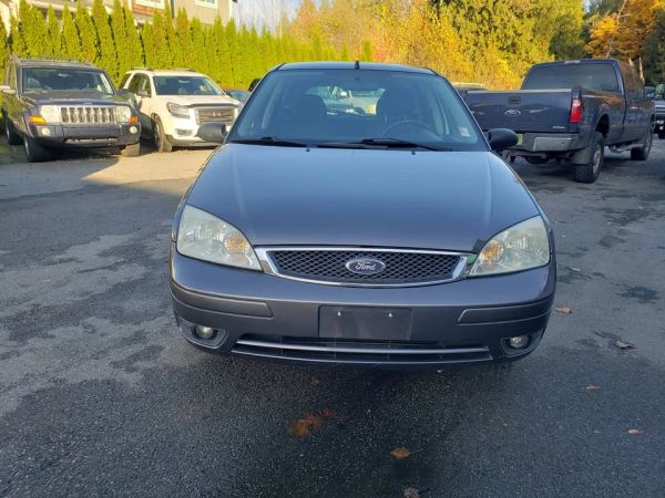 Front view of a gray Ford car parked outdoors.