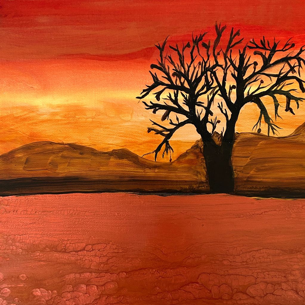 An orange desert with a lone tree.