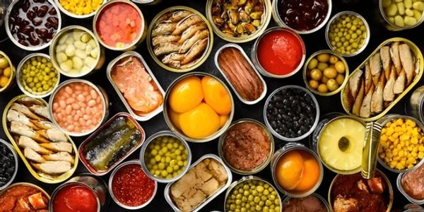 Various opened cans of preserved foods arranged closely together.