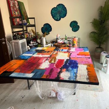 Colorful abstract painting on a table in an art studio.