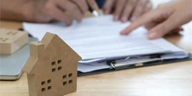 Photo of Real estate planning paperwork and mini house