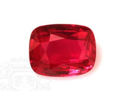 A vibrant red cushion-cut gemstone.